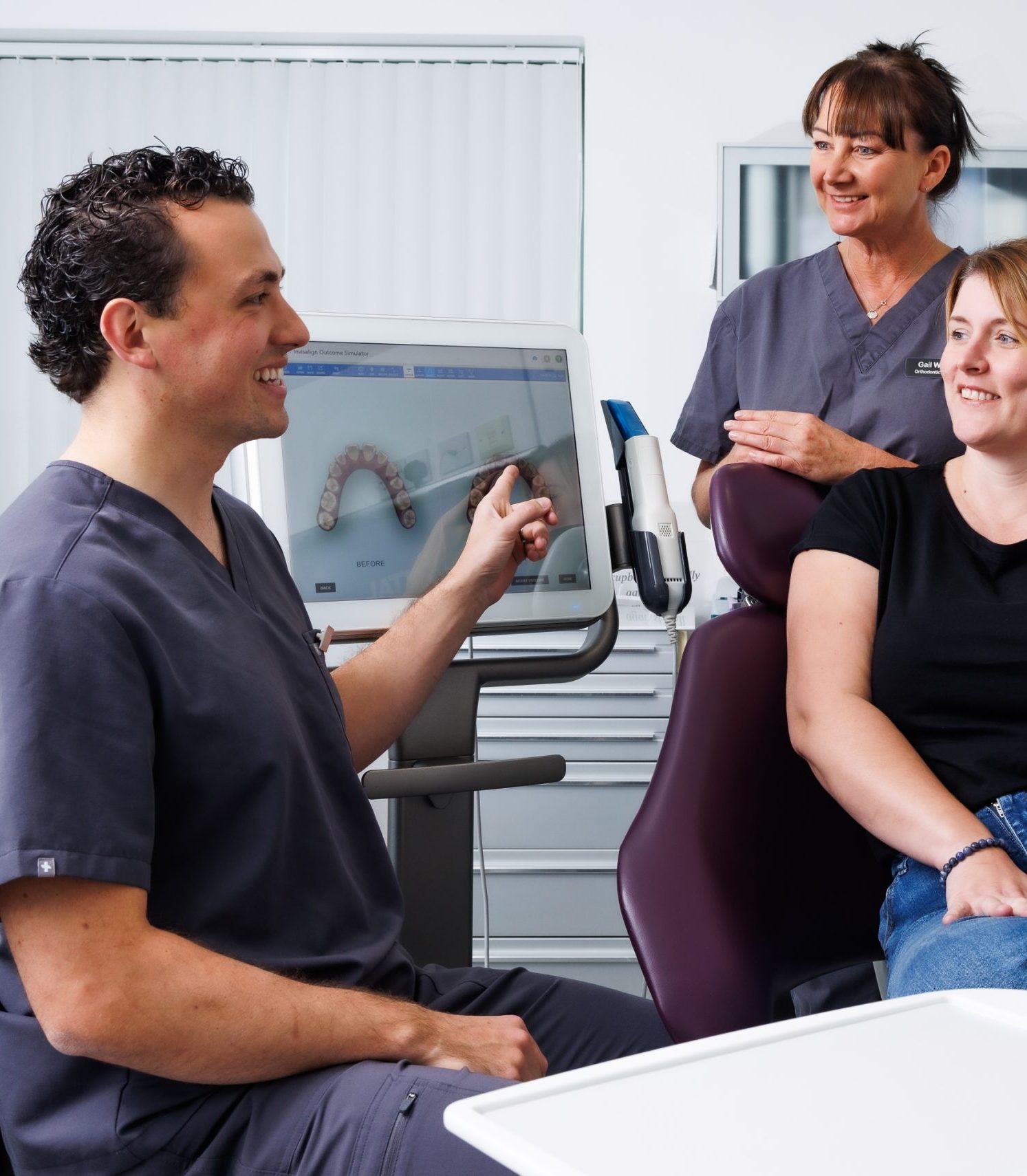 Ortho by Jonty Specialist Orthodontist Dr Jonathan Shelswell pointing to itero scanner screen with Dental Nurse and Patient on dental chair